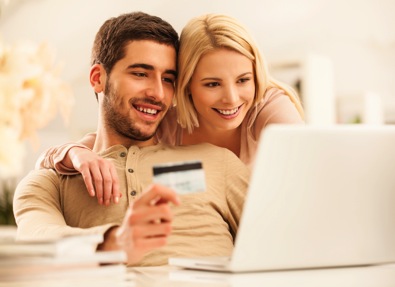 Young couple using e-commerce website to buy online