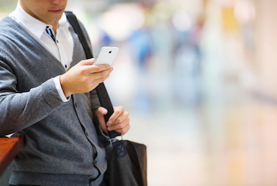 Why Mobile and Data Go Hand-in-Hand for Marketers: Business person using mobile to research product