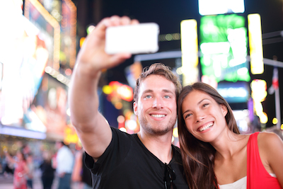 Mobile, Millennials, and hotel marketing: young couple enjoying travel together