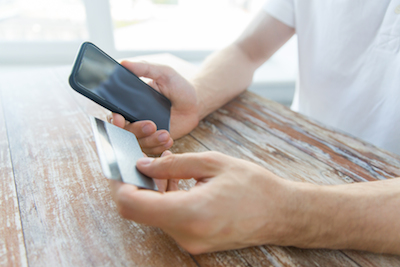 What's holding mobile commerce back? Man shopping on mobile phone