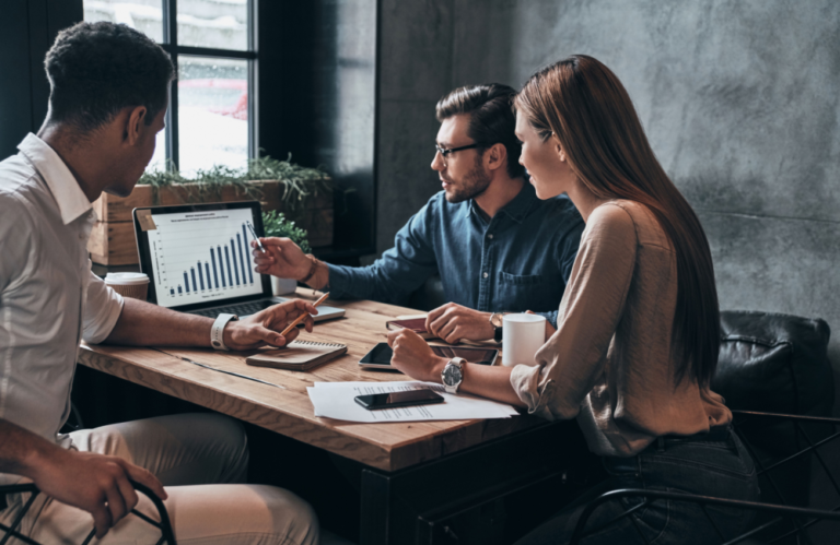 Photo of marketing team working on plan to illustrate the idea of top marketing trends in 2023