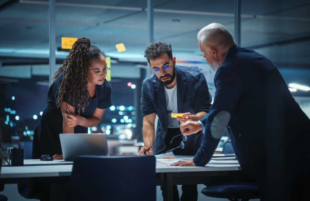 Three professionals collaborating to illustrate the idea that AI won't save a bad strategy